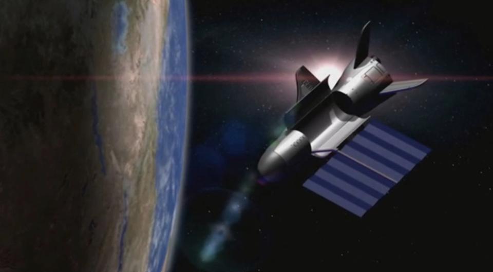 An artist's depiction of the U.S. Air Force's unmanned X-37B space plane in orbit with its solar array deployed and payload bay open. <cite>© United Launch Alliance/Boeing</cite>